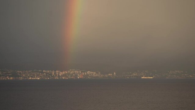 Rainbow and stormy sky over Kvarner Bay across to Rijeka from Lovran, Kvarner Bay