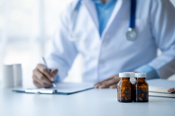 Medicine bottles are placed on the doctor's desk in the hospital examination room, the concept of treatment and symptomatic medication dispensing by the pharmacist.