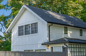 White typical house in Vancouver, Canada. Big house with a patio on sunny summer day.