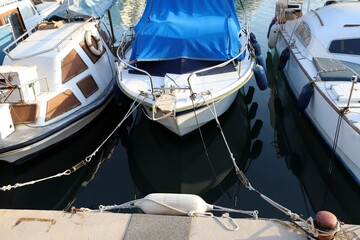 Fototapeta na wymiar Berth for mooring boats and yachts in the seaport.