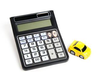 Toy car and calculator white background.Concept buying car.