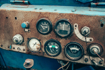 The rusty steel dashboard of a very old tractor close-up