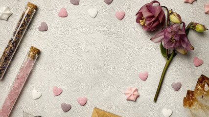 Background with copy space with flower, crystal stones, little hearts around and vials. Magic mockup.