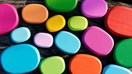 Colorful different size wooden blocks, flat stone shape, top view.
