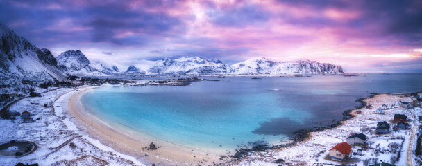 Aerial view of nordic sandy beach, sea in winter at sunset - obrazy, fototapety, plakaty
