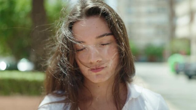 Young hispanic woman smiling confident standing at park