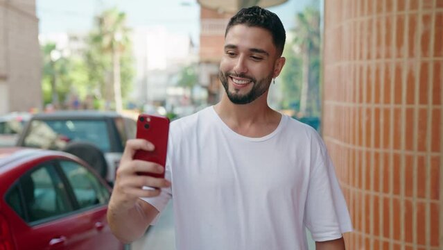 Young arab man smiling confident making selfie by the smartphone at street