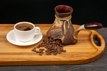 fresh coffee beans fall out of broken ceramic coffee pot