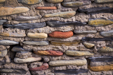 background image of an old wall lined with colored cobblestones and sandstone
