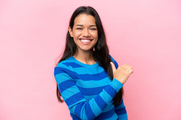 Young Colombian woman isolated on pink background proud and self-satisfied