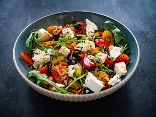 Fresh vegetable salad with feta cheese on wooden table
