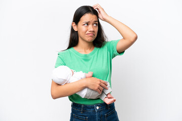 Young Colombian woman with her newborn baby isolated on white background having doubts and with...