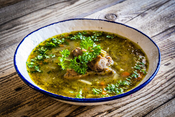 Green bean soup on wooden table
