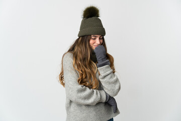 Young caucasian woman with winter hat isolated on white background having doubts