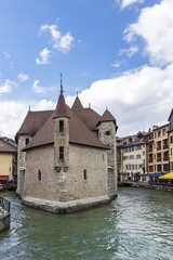 Fototapeta na wymiar Medieval insular Palais de l'Isle (Isle Palace) in Annecy, which date from the 12th century. Isle Palace look like a stone ship. Annecy, Haute-Savoie department, Auvergne-Rhone-Alpes region, France.