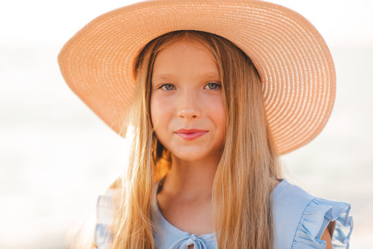 Smiling Blonde Teenage Girl 12-14 Year Old Wear Straw Hat Over Sun Light Outdoor. Look At Camera. Summer Season. Childhood.