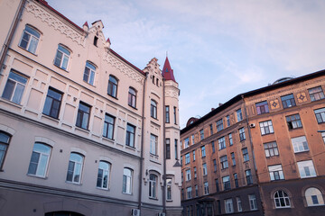 Fototapeta na wymiar Facades of building on a street of Vyborg by summer day