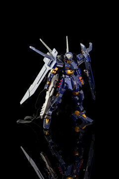Plastic model of Gundam from the Gundam series of Animated TV shows. The model is posed on a black background and is manufactured by Bandai..