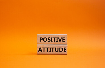 Positive attitude symbol. Concept words Positive attitude on wooden blocks. Beautiful orange background. Business and Positive attitude concept. Copy space.