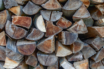 Fototapeta premium stacked chopped firewood. preparation for the heating season. energy. background.