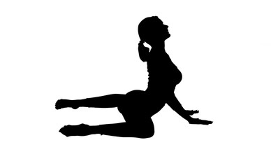 Silhouette of young woman practicing yoga 