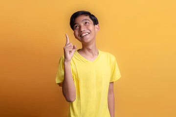 Portrait of Asian young man wearing yellow t-shirt. By describing the experience