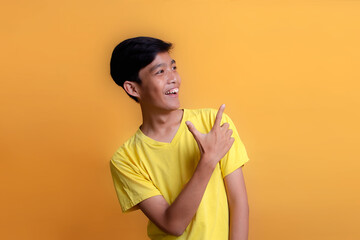 Portrait of Asian young man wearing yellow t-shirt. By describing the experience