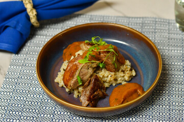 Duo of duck with seared duck breast, confit thigh, mushroom risotto and peach-tomato compote