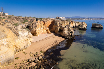 Ponta da Piedade with over rocks near Lagos in Algarve, Portugal. Ponta da Piedade, Algarve region, Portugal. Beach Tourists Umbrellas