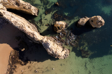 Ponta da Piedade with over rocks near Lagos in Algarve, Portugal. Ponta da Piedade, Algarve region, Portugal. Beach Tourists Umbrellas