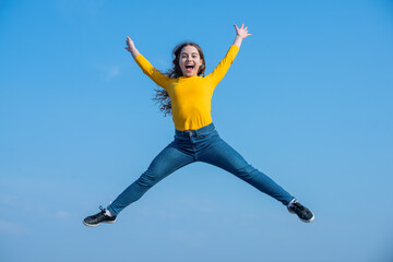 happy teen girl jump high on sky background. happiness