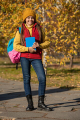 happy teen girl back to school in autumn. full length