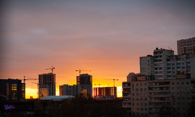 Fototapeta na wymiar Ukraine city Kyiv. Construction of new high-rise buildings against the background of the evening sky.