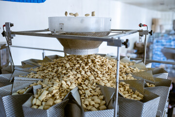 sorting and packing line of stuffed breakfast cereal pillows at factory conveyor for cereal snack...