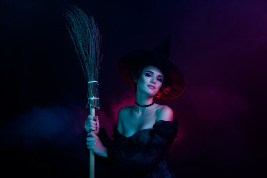 Photo of stunning magician lady holding flying broom stick night isolated on ultra colored background