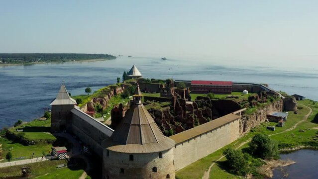 Aerial footage of ancient fortress Oreshek on an island at the mouth of the Neva River on a sunny day, St. Petersburg, Russia