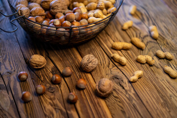 different kinds of nuts on a wooden background