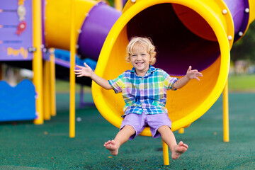 Child on playground. Kids play outdoor.