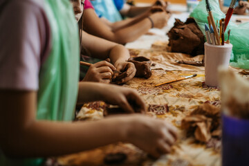 children's hands sculpts clay crafts pottery school