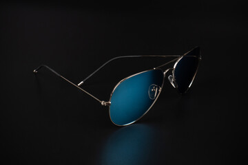 blue polarized sunglasses in dark background.