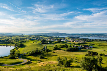 Fototapeta na wymiar Meadow landscape with a view of Lake Zurich - Wollerau, Switzerland