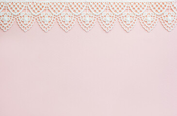 Vintage handmade lace on pale pink background. Banner for creative studio on the top. Copy space