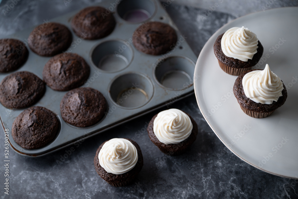 Canvas Prints chocolate cupcake with white icing on dark background