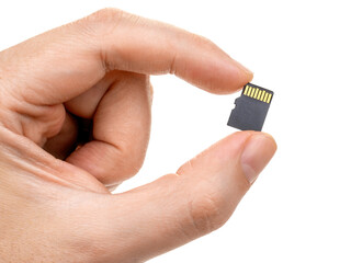 A man's hand holds a micro sd card with two fingers. Isolated on white background