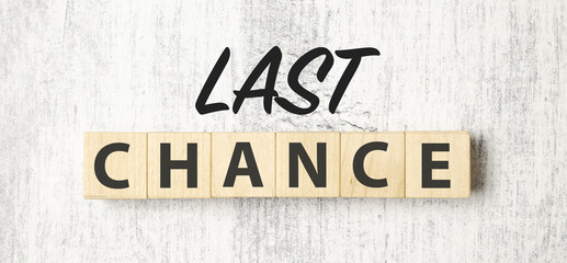 Time to last chance symbol. Concept words Last chance on wooden blocks