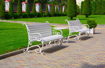 White benches on the street in the city of Chisinau in Moldova.