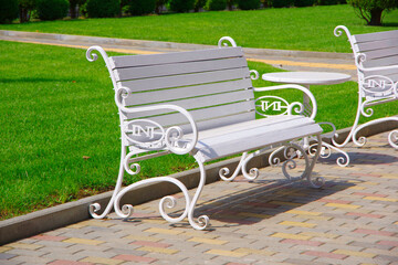 White benches on the street in the city of Chisinau in Moldova.