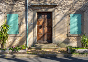 A typical derelict facade with closed shutters in a Southern France village
