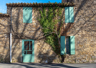 A typical derelict facade with closed shutters in a Southern France village