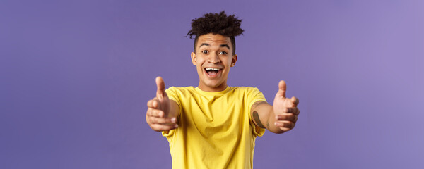Close-up portrait of charismatic, happy friendly-looking hispanic man with dreads reaching hands...